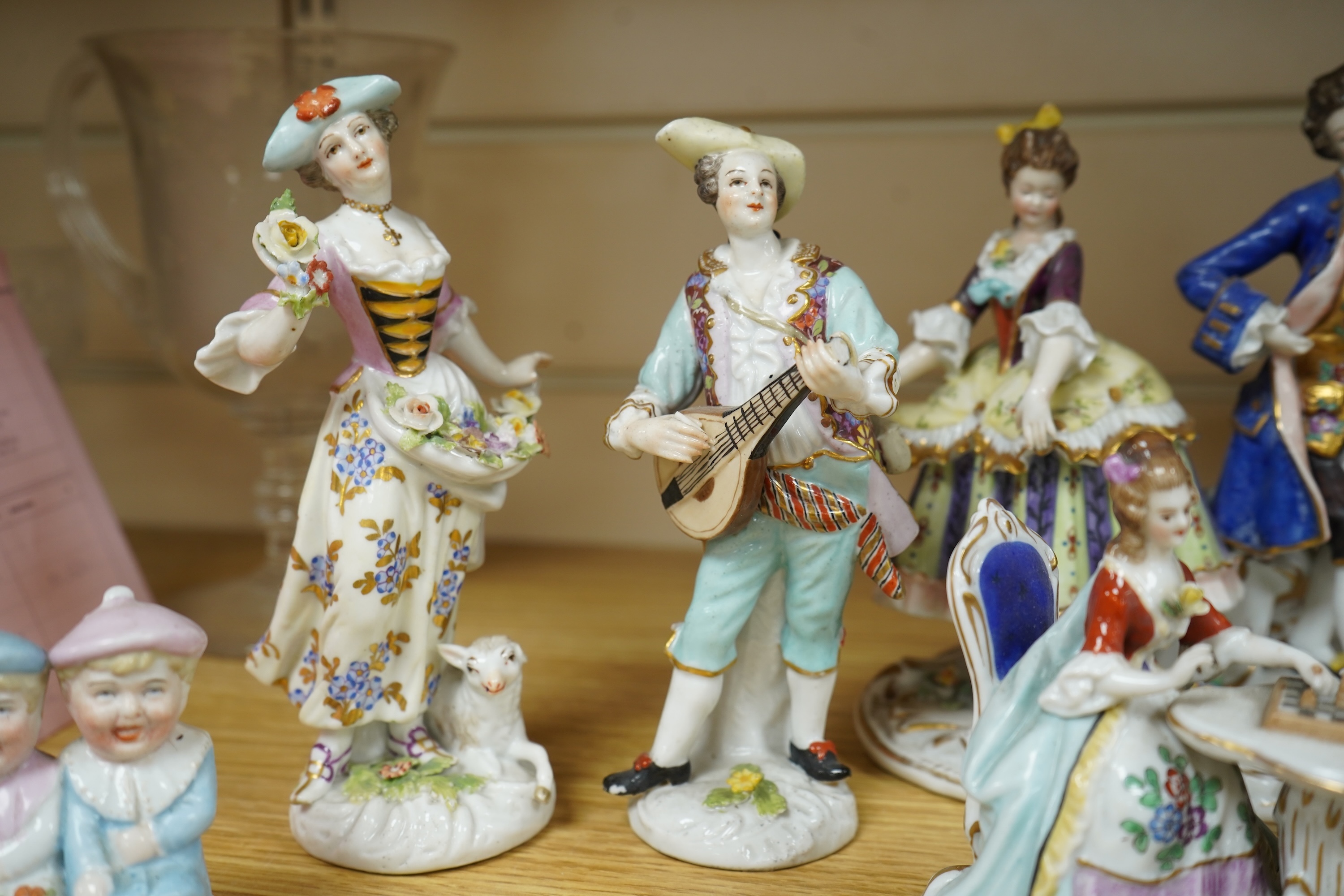 A French porcelain figure of a Mansion House dwarf, various German porcelain figures, an engraved glass and bowl. Glass 19cm
